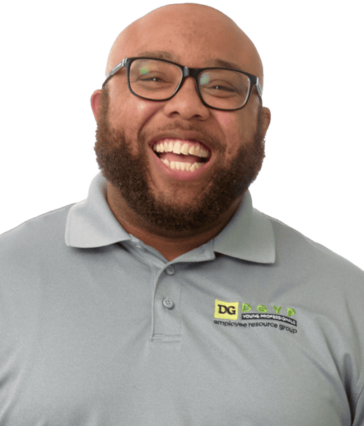 A man with a beard and glasses, smiling widely, wears a light gray polo shirt with a “DG Young Professionals employee resource group” logo on it.
